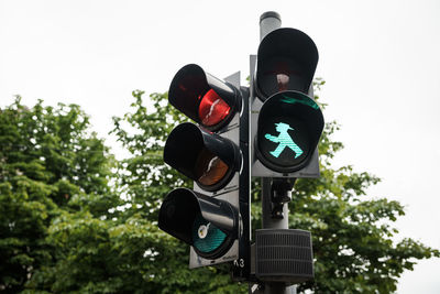 Low angle view of road signal against sky