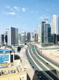 High angle view of street amidst buildings against sky