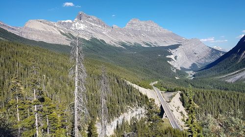 Panoramic view of mountain range against blue sky