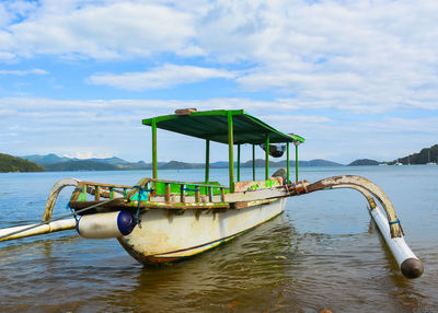 Boat moored in sea against sky