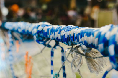 Close-up of tied hanging on rope