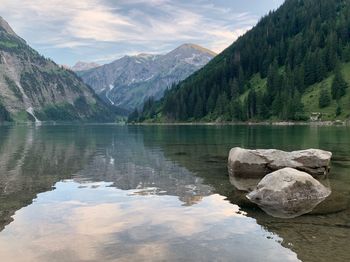 Scenic view of lake and mountains against sky