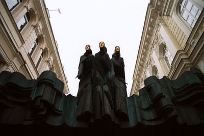 Low angle view of statues against clear sky