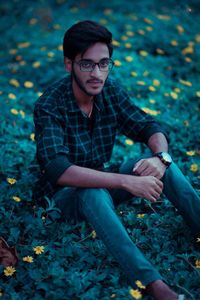 Portrait of young man sitting outdoors