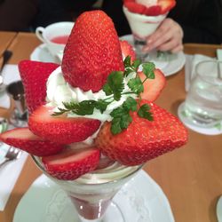 Close-up of strawberries with ice cream in glass on table