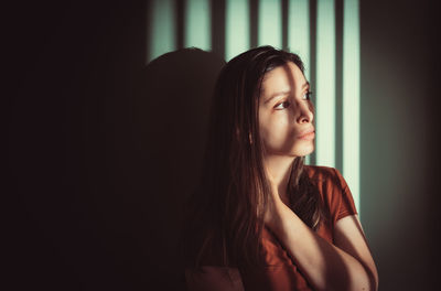 Portrait of young woman looking away