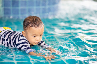 Portrait of boy swimming in pool