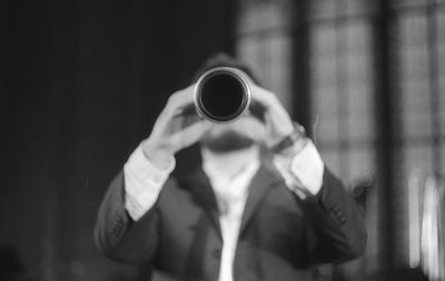 Man playing clarinet while standing at studio