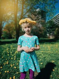 Girl wearing flowers standing on field