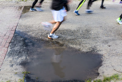 Low section of people walking on street during rainy season