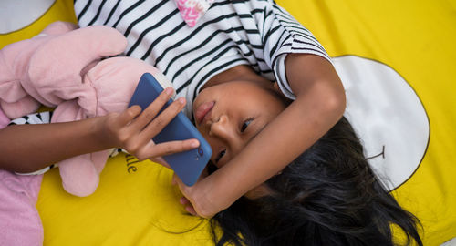 Low angle view of woman using mobile phone