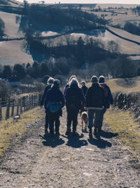 Rear view of people standing on landscape