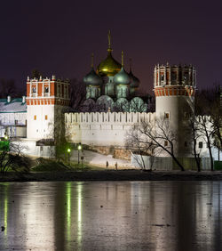 Illuminated building against sky at night