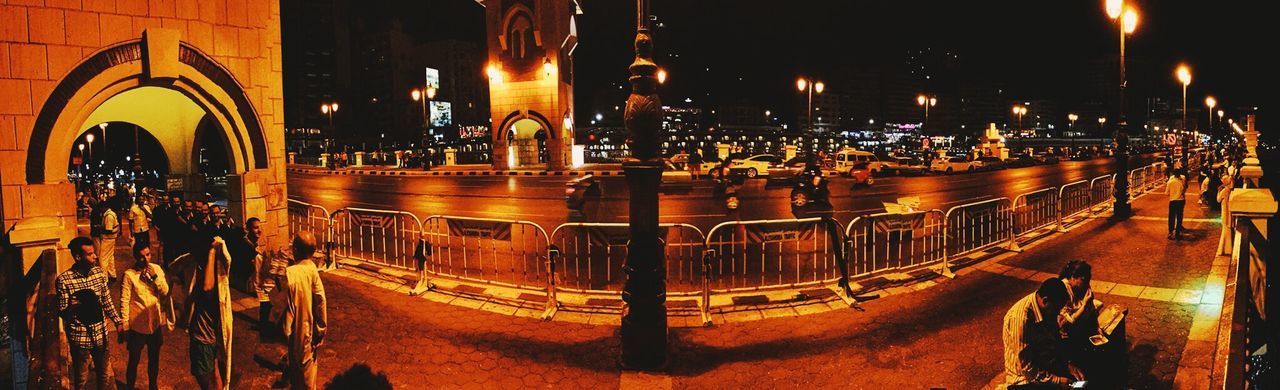 HIGH ANGLE VIEW OF ILLUMINATED STREET BY BUILDINGS AT NIGHT