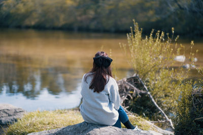 Woman sitting alone near the river