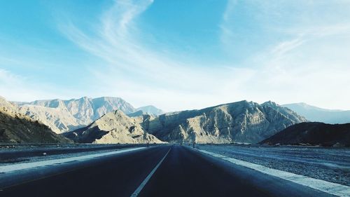 Road amidst mountains against sky