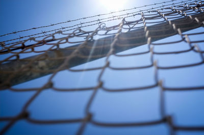 Low angle view of power lines against sky