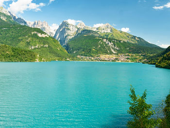 The town and lake with same name molveno lake nestled in the dolomites in trentino alto adige, italy