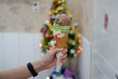 Close-up of hand holding ice cream cone