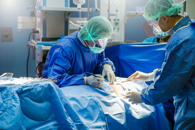 Surgeons operating patient at hospital