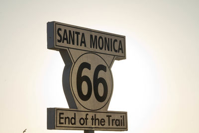 Low angle view of information sign against clear sky