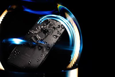 Close-up of illuminated lighting equipment against black background