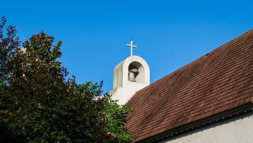 Low angle view of bell tower against sky