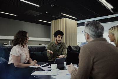 Group of business people having meeting in lobby