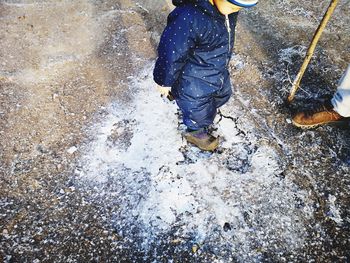 Low section of man standing in water