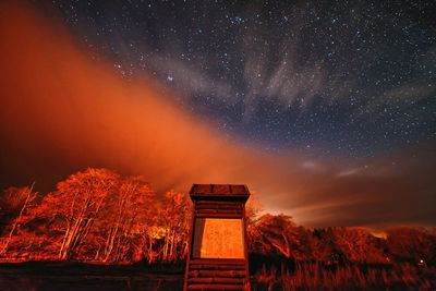 Low angle view of landscape against sky at night