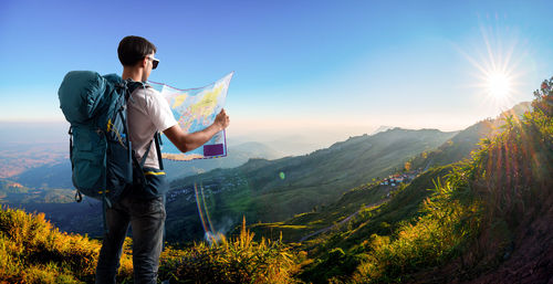 Man standing on mountain against sky