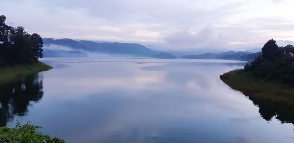 Scenic view of lake and mountains against sky