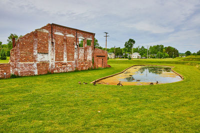 Built structure on field against sky