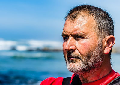 Close-up portrait of man with reflection in water