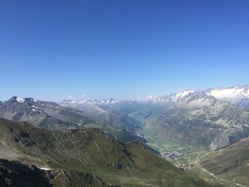 Scenic view of snowcapped mountains against clear blue sky