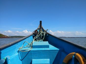 Boat in swimming pool by sea against blue sky