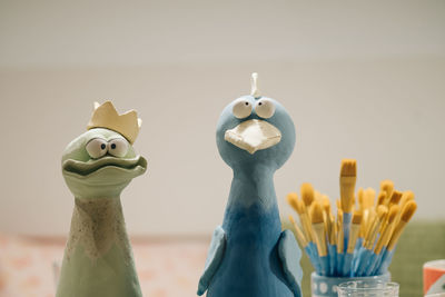 Close-up of ceramic figurines by paintbrushes