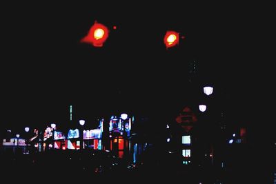 Illuminated street lights in city at night