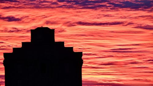 Silhouette temple against sky during sunset