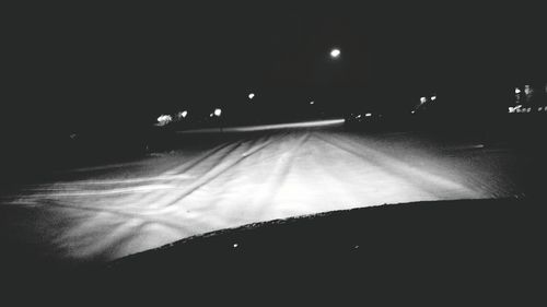 View of illuminated road at night