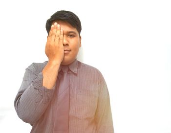 Portrait of man looking away against white background