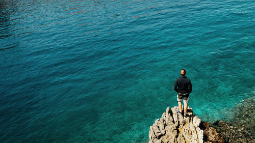 Rear view of man looking at sea