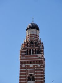 Low angle view of building against clear blue sky