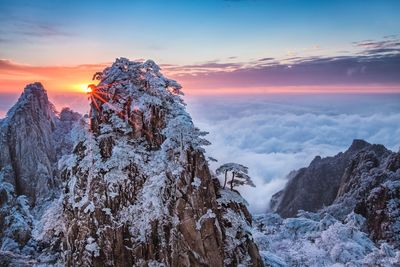 Scenic view of mountains against sky during sunset in winter