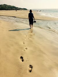 Tourists walking on beach