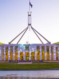 Low angle view of flags against clear sky