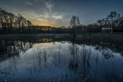 Scenic view of lake against sky at sunset