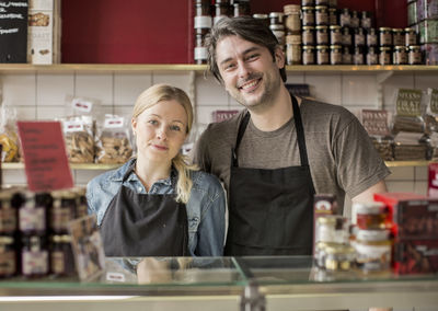 Portrait of smiling worker standing in supermarket