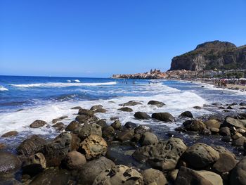 Scenic view of sea against clear blue sky