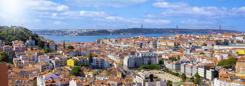 High angle view of townscape by sea against sky